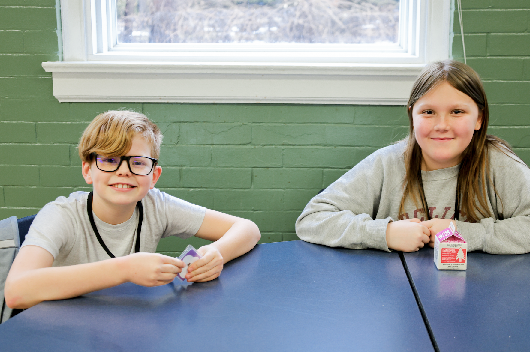 Two Youth Developments kids having a snack at our after school program.